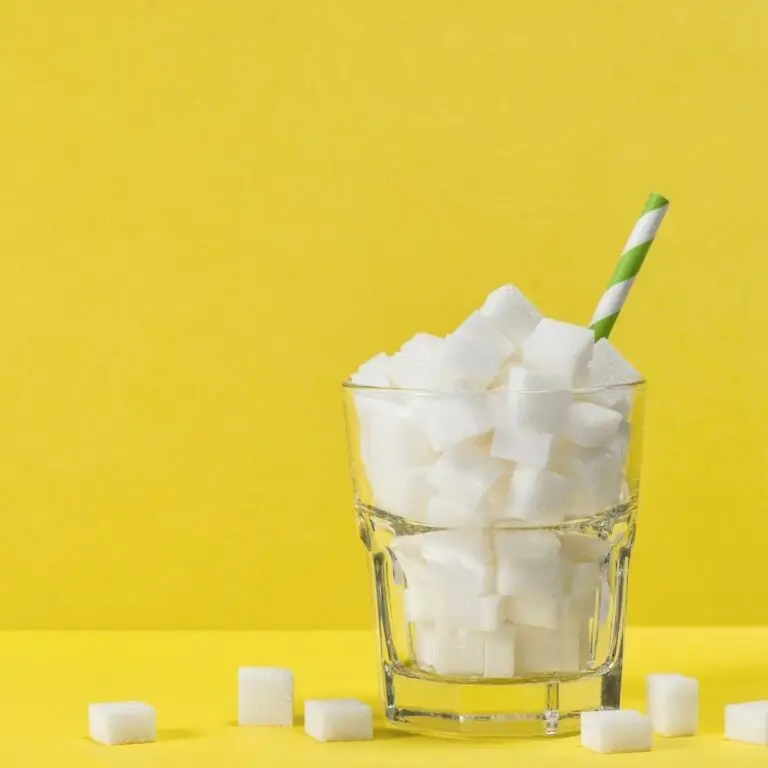Glass filled with sugar cubes and straw