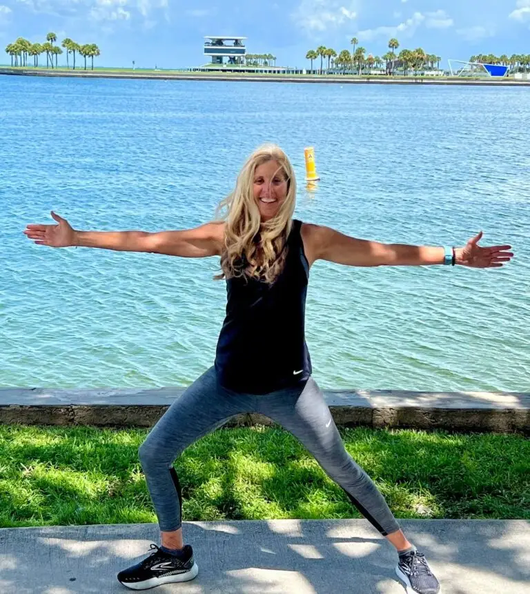 Woman exercising by the waterfront on a sunny day.